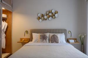 ein Schlafzimmer mit einem großen Bett mit weißen Kissen in der Unterkunft Acropolis Exclusive Studio in Athen