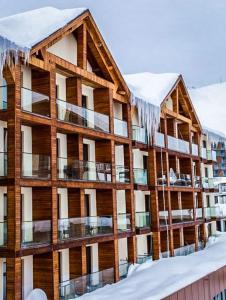 an apartment building with icicles hanging from it in the snow at New Gudauri Lofts by Gudauri Travel in Gudauri