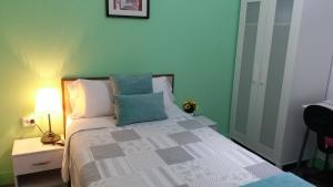 a bedroom with a bed with a blue wall at Pensión Mar Azul in Santiago de Compostela