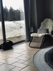 a room with a window looking at a snow covered yard at Sjöborg Säng & Bassäng in Munka-Ljungby