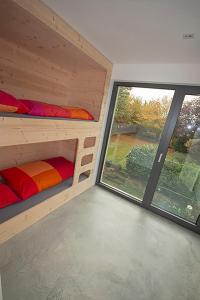 a room with two bunk beds and a large window at Historisches Wohnen modern interpretiert in Kirrweiler