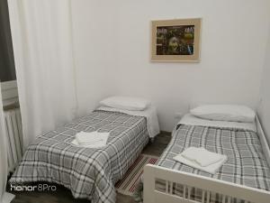 two beds in a small room with white walls at Casa Viorica in Ancona +24 photos