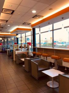 a restaurant with chairs and tables and windows at ibis budget Katowice Centrum in Katowice