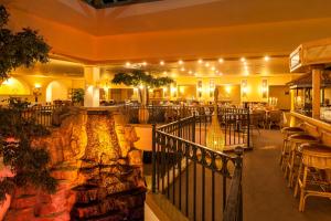 a restaurant with tables and chairs in a building at Wyndham Garden Donaueschingen in Donaueschingen