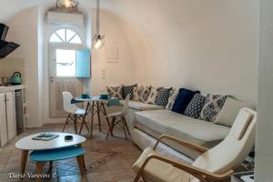 a living room with a couch and a table at Santorinian Lava House in Pyrgos