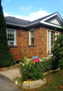 a brick house with a garden in front of it at The Nottawa Gem, Blue Mountain & Collingwood in Nottawa