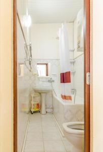 ein weißes Bad mit einem Waschbecken und einem WC in der Unterkunft Квартира по улице Цитадельная 4 in Kiew