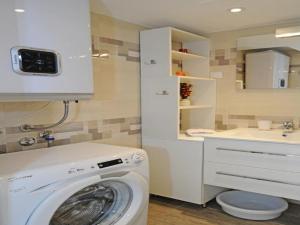 ein Badezimmer mit einer Waschmaschine und einem Waschbecken in der Unterkunft Atento Apartments in Dubrovnik