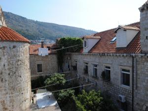 a group of buildings with mountains in the background at Atento Apartments in Dubrovnik