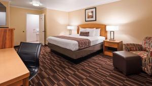 a hotel room with a bed and a chair at Best Western Plus Ontario Airport & Convention Center in Ontario
