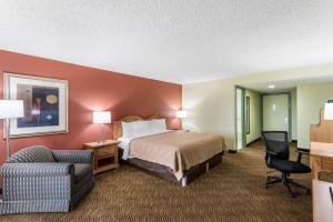 a hotel room with a bed and a chair at Quality Inn Payson in Payson
