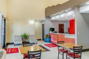 a lobby with tables and chairs and a kitchen at Econo Lodge West - Coors Blvd in Albuquerque