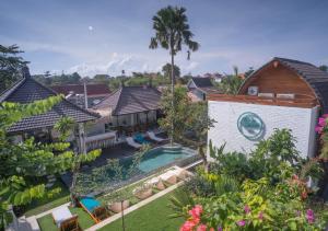 an aerial view of a house with a swimming pool at The Palms Canggu in Canggu
