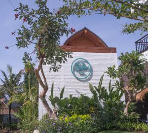 a building with a sign on the side of it at The Palms Canggu in Canggu