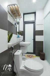 a bathroom with a toilet and a sink at Na Homestay in Hue