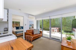 a living room with a kitchen and a dining room at The Victoria Apartments in Port Fairy