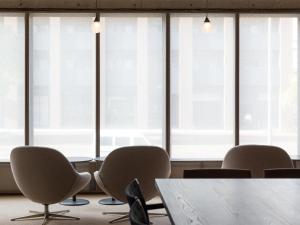 a conference room with chairs and a table and windows at THE HOTELS HAKATA KASANE Bayside in Fukuoka
