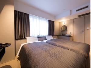 a hotel room with two beds and a window at THE HOTELS HAKATA KASANE Bayside in Fukuoka +121 photos