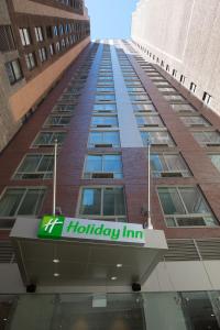 a building with a holiday inn sign on it at Holiday Inn New York City - Times Square, an IHG Hotel in New York