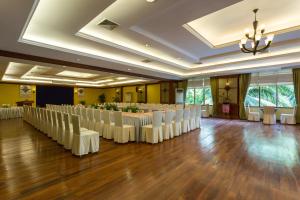 a large banquet hall with white chairs and tables at Prince Angkor Hotel & Spa in Siem Reap +37 photos