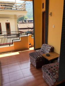 バトゥにあるVilla Cahaya 9のソファ、テーブル、バルコニーが備わる客室です。 +2枚の写真