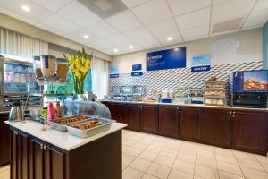 a fast food restaurant with a counter with pastries at Holiday Inn Express San Jose Costa Rica Airport by IHG in Alajuela City