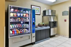 a refrigerator filled with lots of soda at Holiday Inn Express San Jose Costa Rica Airport by IHG in Alajuela City