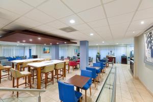 a dining room with tables and chairs in a building at Holiday Inn Express San Jose Costa Rica Airport by IHG in Alajuela City