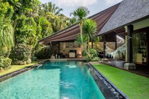 a swimming pool in the backyard of a house at Ametis Villa -Adult Only in Canggu