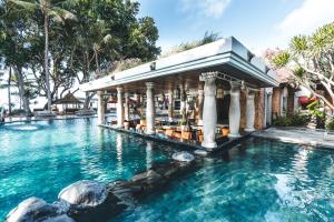 a pool at a resort with a gazebo at Puri Santrian in Sanur
