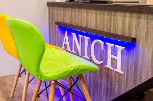 two green chairs sitting in front of a tv at 安尼赫時尚旅店 Anich Fashion Inn in Kenting