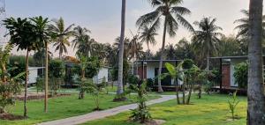 a view of a resort with palm trees at Koh Kood Chalet in Ban Hin Dam