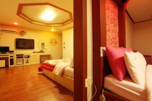 a hotel room with a bed and a television at Motel Nine in Daejeon