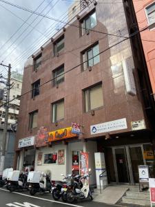 a group of motorcycles parked in front of a building at Hostel Anchorage in Kobe