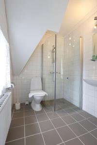 uma casa de banho com um chuveiro e um WC. em Ardrebo B&B em Ljugarn