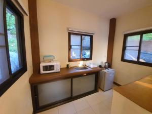 a kitchen with a sink and a microwave on a counter at Moonstone Studio in Haad Rin