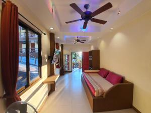 a living room with a couch and a ceiling fan at Moonstone Studio in Haad Rin