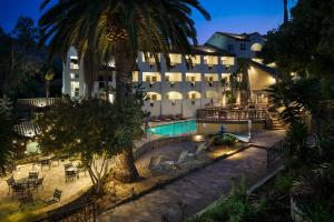 a hotel with a swimming pool at night at Catalina Canyon Inn in Avalon