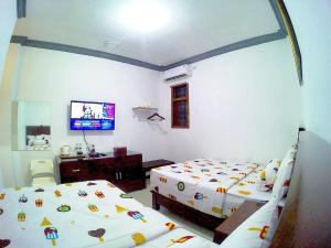 Letto o letti in una camera di Amaryllis Guesthouse Syariah
