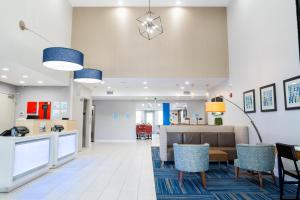 a lobby of a hospital with a table and chairs at Holiday Inn Express & Suites - Lake Forest, an IHG Hotel in Lake Forest