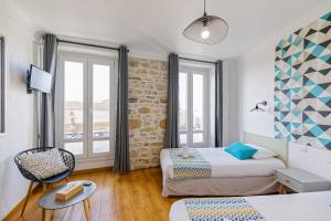 Hotel Cote Basque tesisinde bir odada yatak veya yataklar