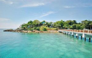 a bridge over the water next to an island at Banglo Semi D Villa D Doa Maju in Kuala Terengganu