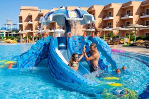 a man and a woman are in a swimming pool at The Three Corners Sunny Beach Resort in Hurghada