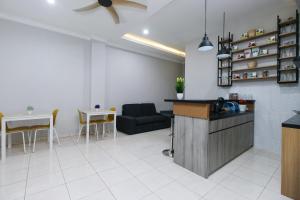 cocina y sala de estar con sofá y mesa en RedDoorz Syariah @ Cinere Depok en Depok