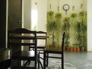 a table and chairs in a room with potted plants at Goodhope Hotel Shah Alam in Shah Alam +11 photos