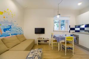 a living room with a couch and a table at Apartment Sun & Sea in Split