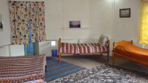 A bed or beds in a room at Karen Camp & Hostel