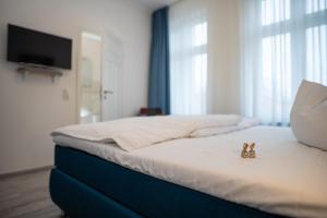 Postel nebo postele na pokoji v ubytování Hotel Hanseat Stralsund