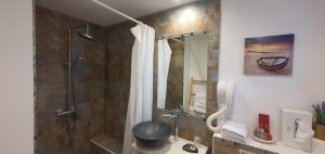 a bathroom with a shower with a shower curtain at Hotel Cote d'Argent in Lacanau-Océan