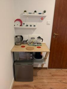 a small kitchen with a counter and a table at Apartamencik Centrum in Polanica-Zdrój